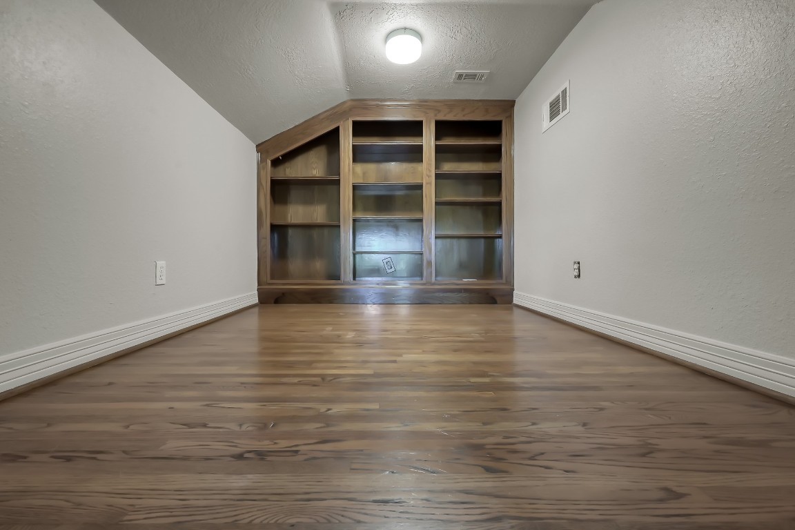 12758 Aries Loop Willis, TX 77318 - Photo 29 of 48 a view of an empty room with a window and wooden floor