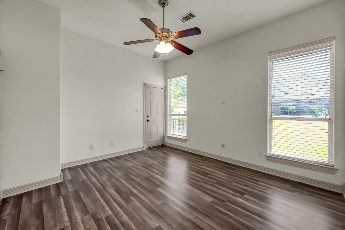 12758 Aries Loop Willis, TX 77318 - Photo 44 of 48 a view of an empty room with wooden floor and a window