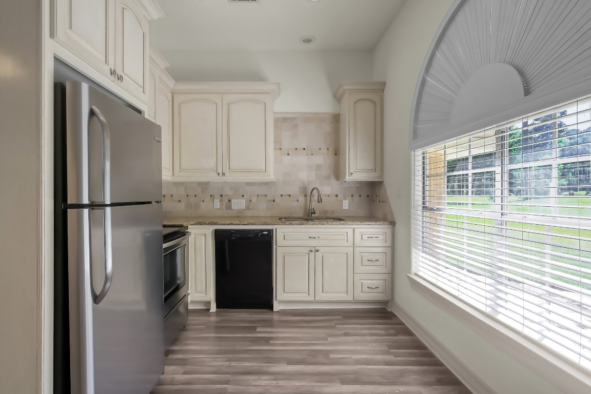 12758 Aries Loop Willis, TX 77318 - Photo 46 of 48 a kitchen with stainless steel appliances granite countertop a refrigerator sink and cabinets