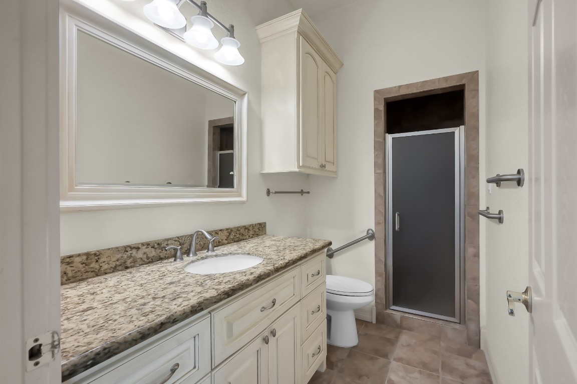 12758 Aries Loop Willis, TX 77318 - Photo 47 of 48 a bathroom with a granite countertop sink and a mirror