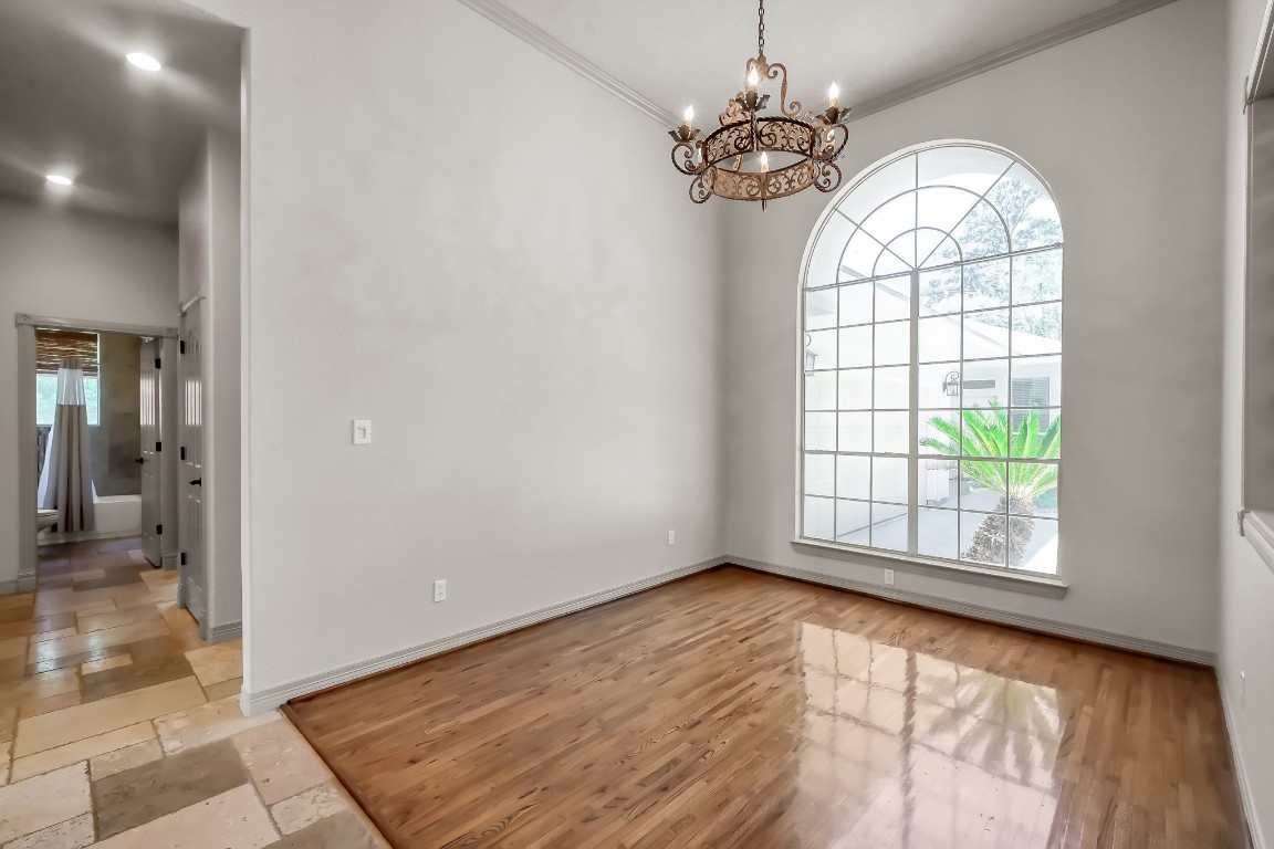 12758 Aries Loop Willis, TX 77318 - Photo 7 of 48 wooden floor in an empty room with a window