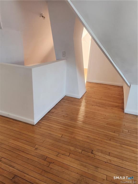 141 Hicks Street Bridgeport, CT 06608 - Photo 13 of 16 a view of an empty room with wooden floor