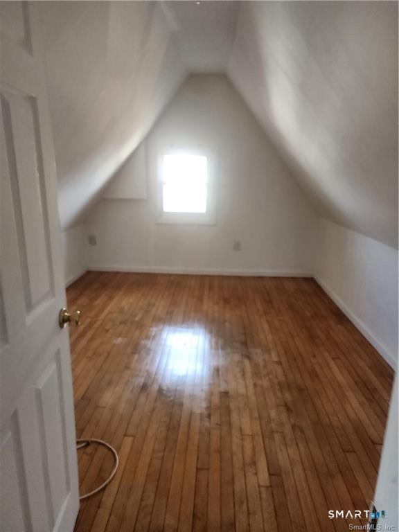 141 Hicks Street Bridgeport, CT 06608 - Photo 15 of 16 an empty room with wooden floor and windows