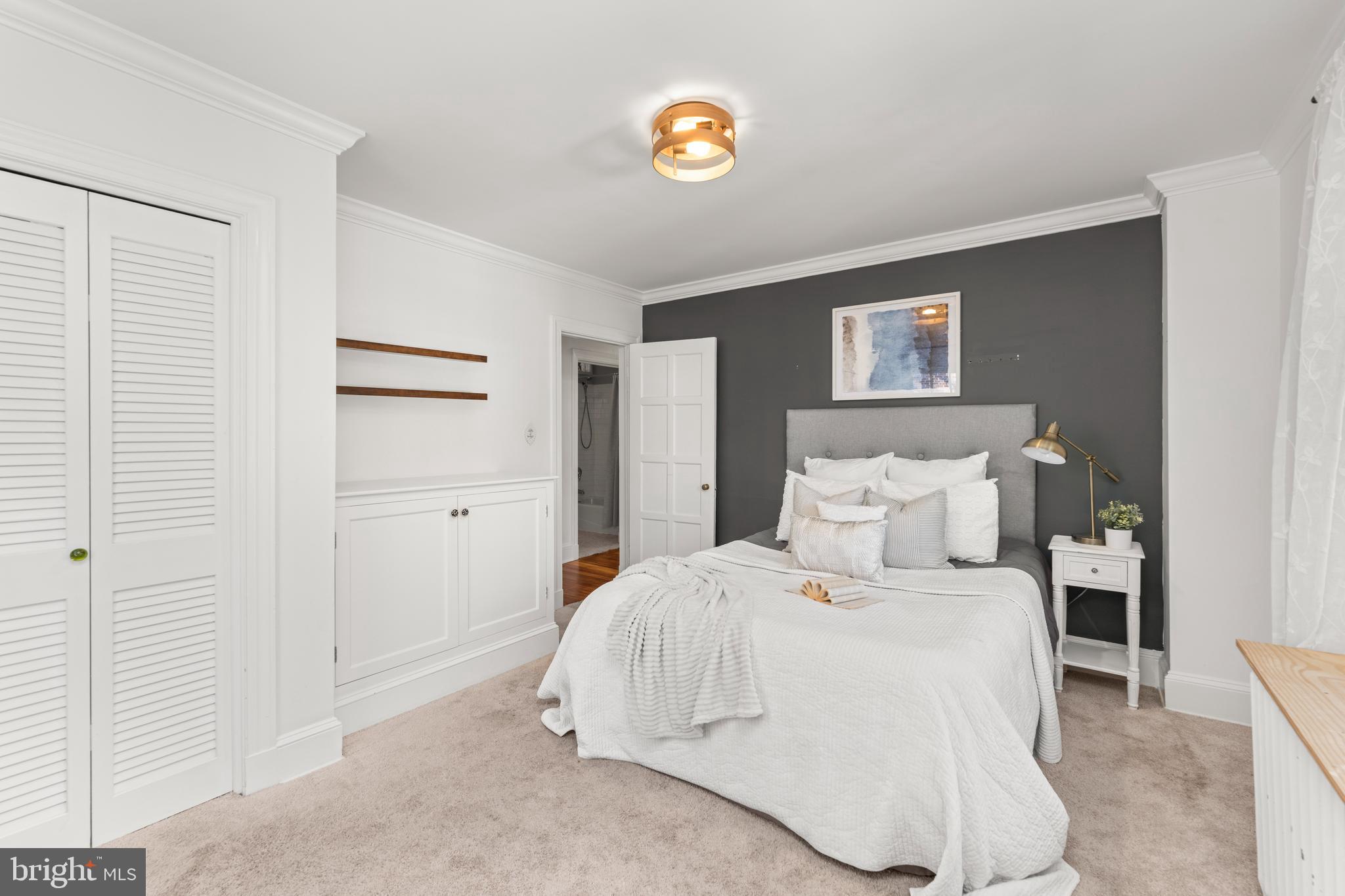 910 Kingston Road Baltimore, MD 21212 - Photo 25 of 36 a bedroom with a bed and a lamp