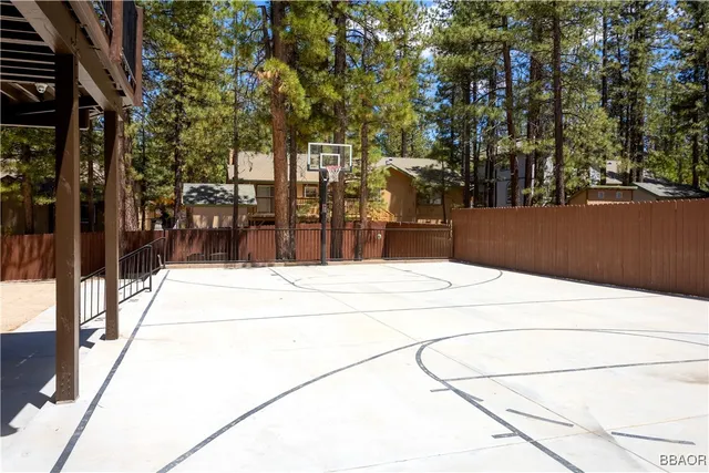 a living room with furniture a dining table and paintings on the wall