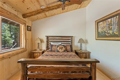 a bedroom with bed and wooden floor