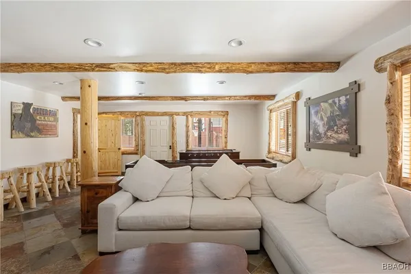 a living room with furniture and a dining table