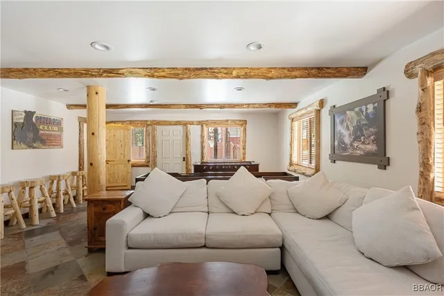 a living room with furniture and a dining table