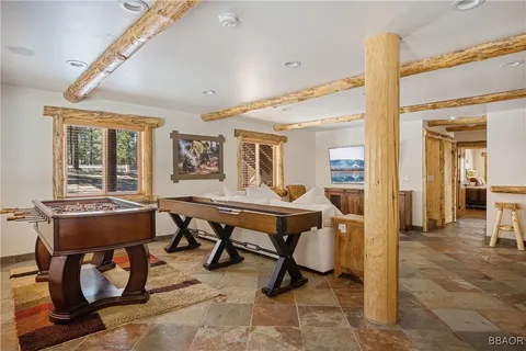 a room with furniture pool table and windows