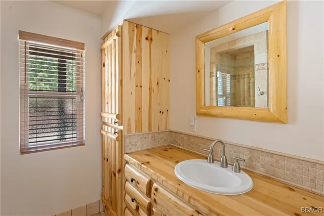 a bathroom with a tub sink and mirror
