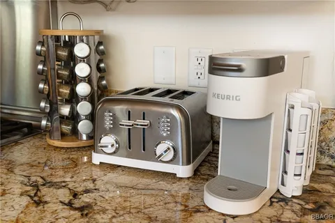 a dining room with furniture a chandelier and wooden floor