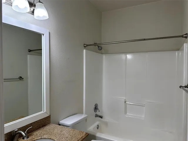 a bathroom with a tub and a shower