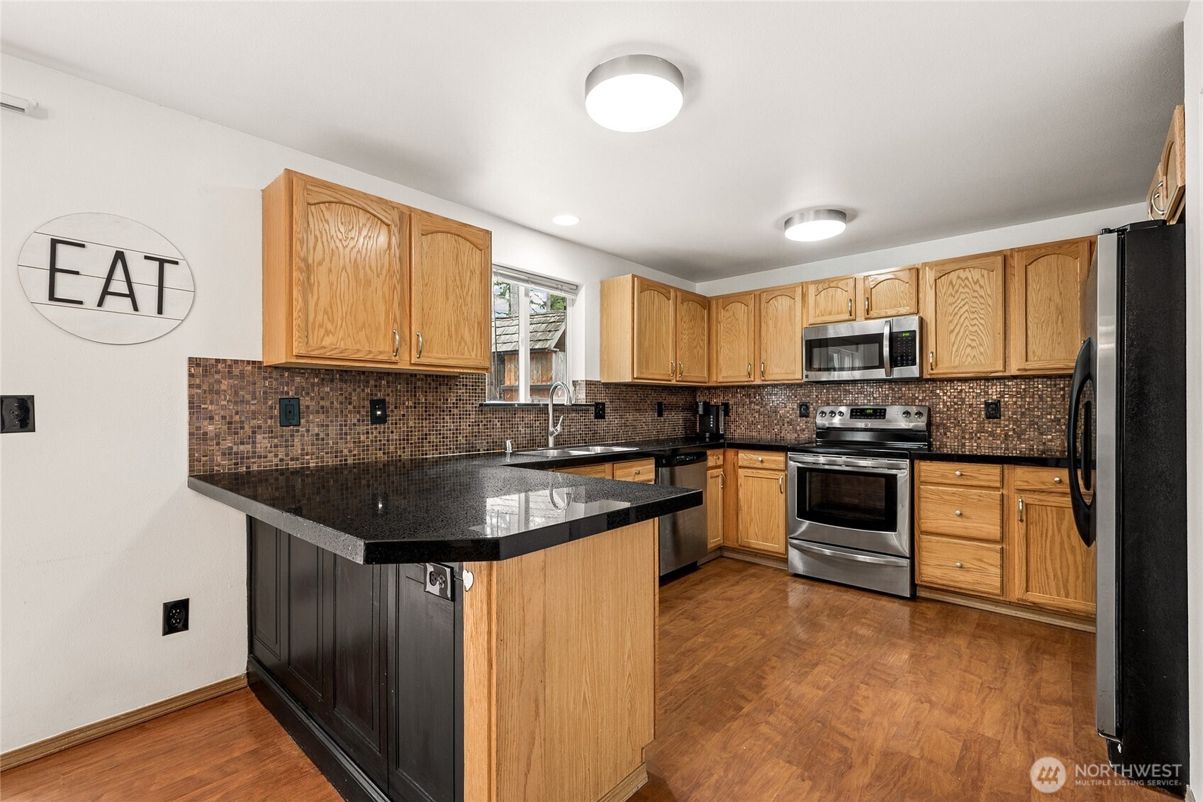 17535 Loop Lane Southeast Yelm, WA 98597 - Photo 12 of 30 a kitchen with stainless steel appliances granite countertop a sink stove and refrigerator
