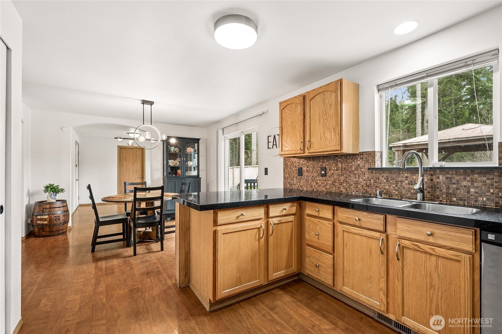 17535 Loop Lane Southeast Yelm, WA 98597 - Photo 13 of 30 a kitchen with white cabinets and wooden floors