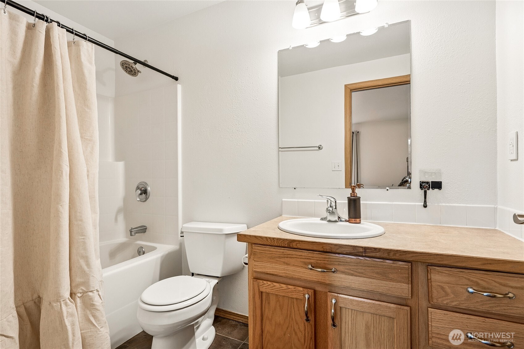17535 Loop Lane Southeast Yelm, WA 98597 - Photo 24 of 30 a bathroom with a sink toilet and shower