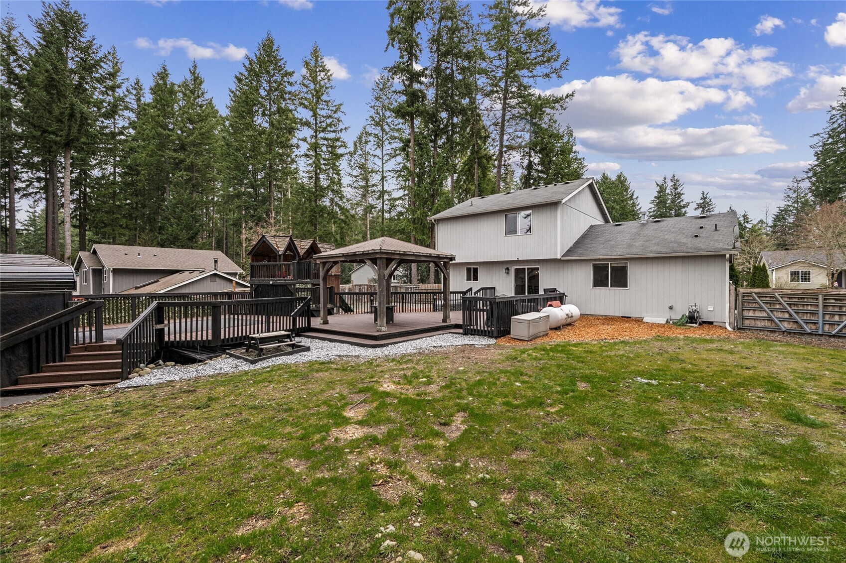 17535 Loop Lane Southeast Yelm, WA 98597 - Photo 29 of 30 a view of a house with table and chairs under an umbrella