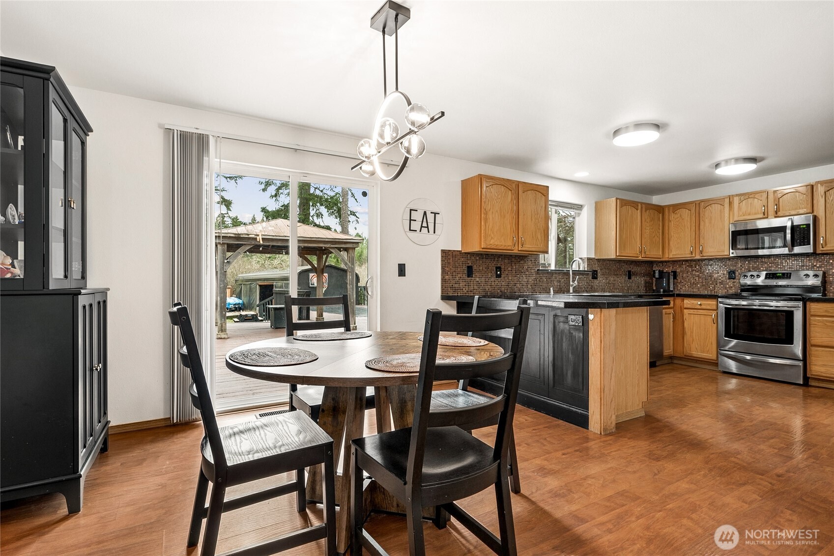 17535 Loop Lane Southeast Yelm, WA 98597 - Photo 9 of 30 a kitchen with stainless steel appliances granite countertop a stove a refrigerator a kitchen island a table and chairs