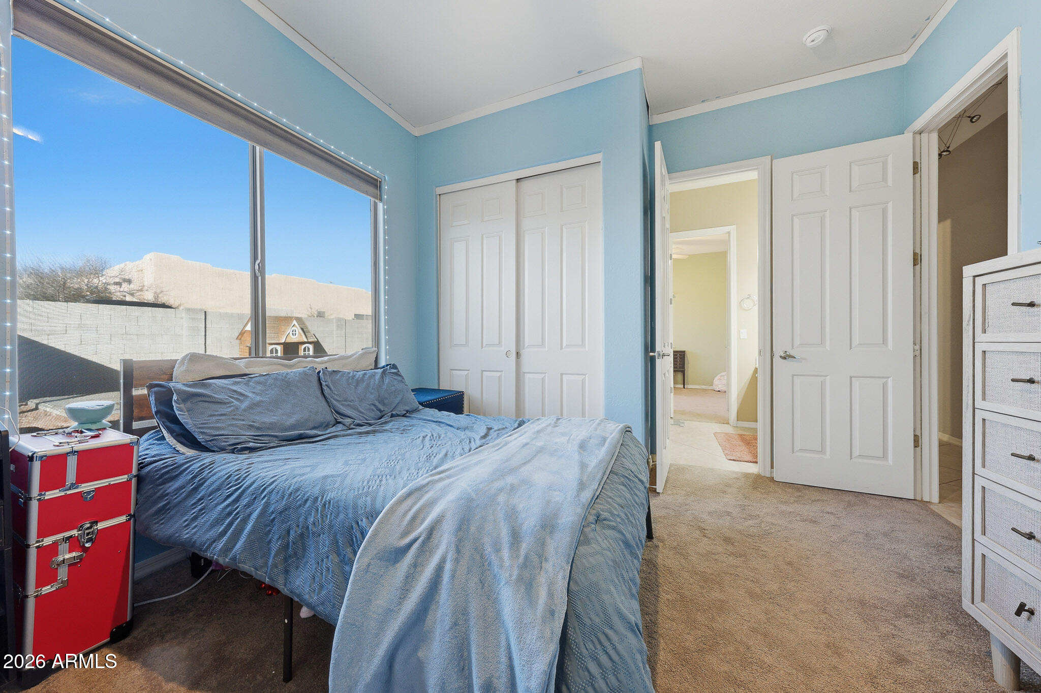 23024 West Sierra Ridge Way Wittmann, AZ 85361 - Photo 16 of 99 a bedroom with a bed and a chandelier