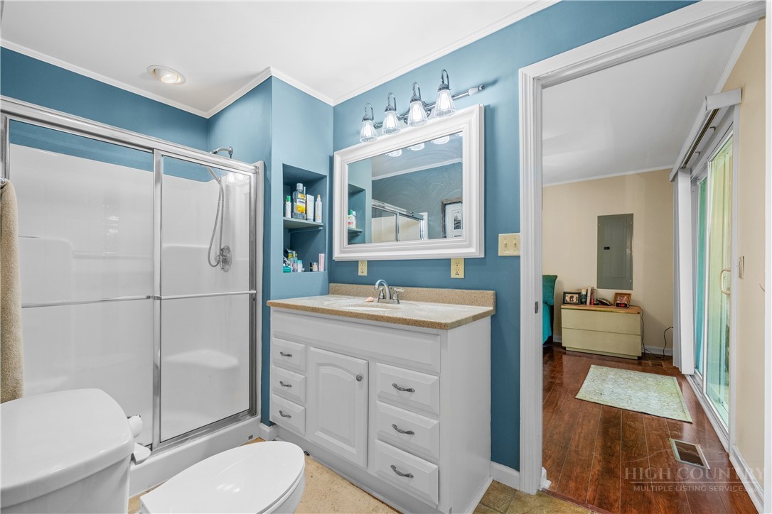 467 Horseshoe Ridge Road East Deep Gap, NC 28618 - Photo 28 of 46 a spacious bathroom with a granite countertop sink toilet mirror and a bathtub