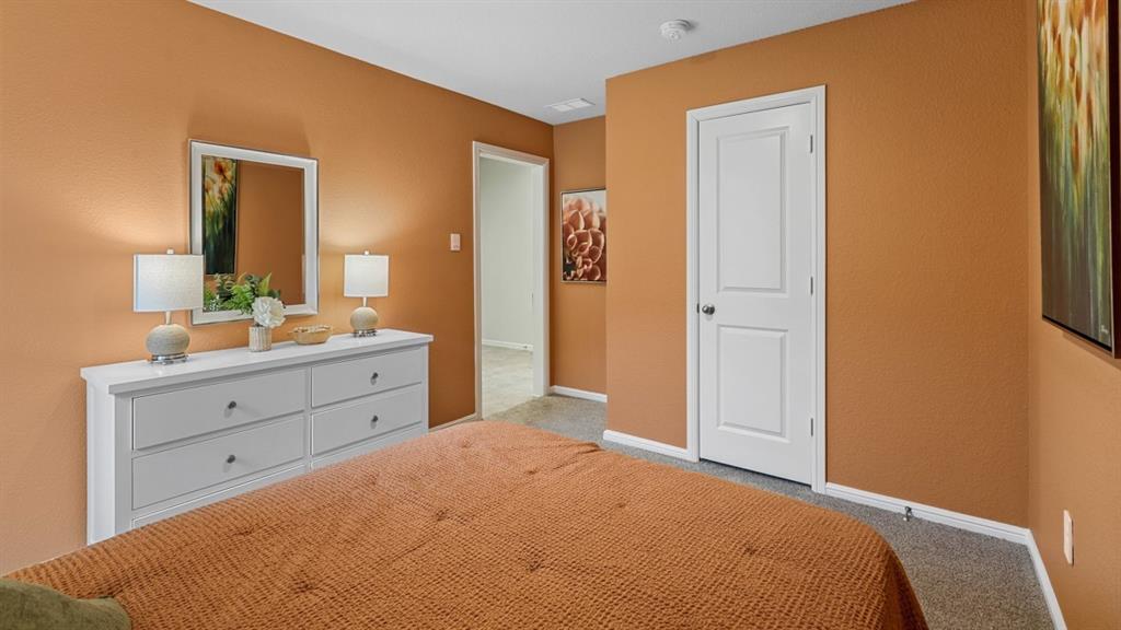 16421 Hudson Pr Way Justin, TX 76247 - Photo 27 of 39 a bed room with a bed and a mirror