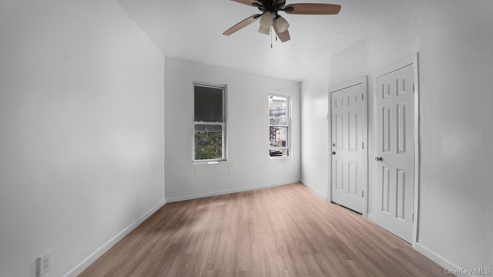 681 Rhinelander Avenue Bronx, NY 10462 - Photo 14 of 30 Unfurnished bedroom with wood finished floors and ceiling fan