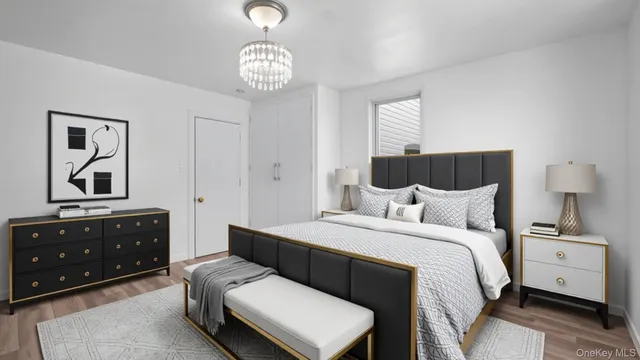 a bedroom with a bed a lamp and a dresser