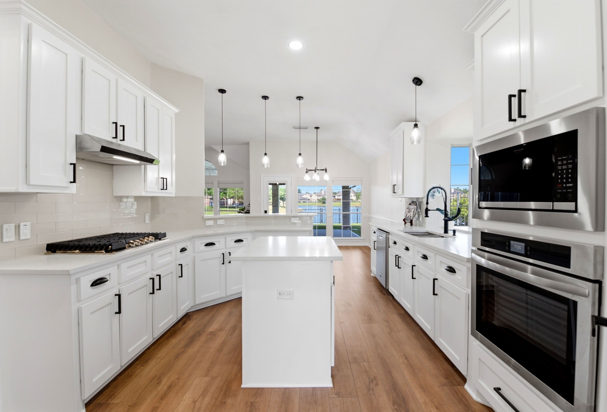 29819 South Legends Village Circle Spring, TX 77386 - Photo 15 of 48 a kitchen with stainless steel appliances a stove sink microwave and cabinets
