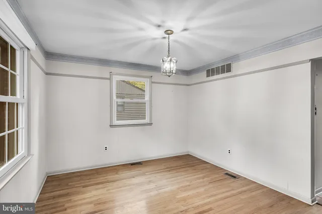 a kitchen with white cabinets and a sink