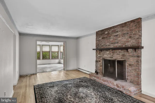 a view of an empty room with a fireplace and a window