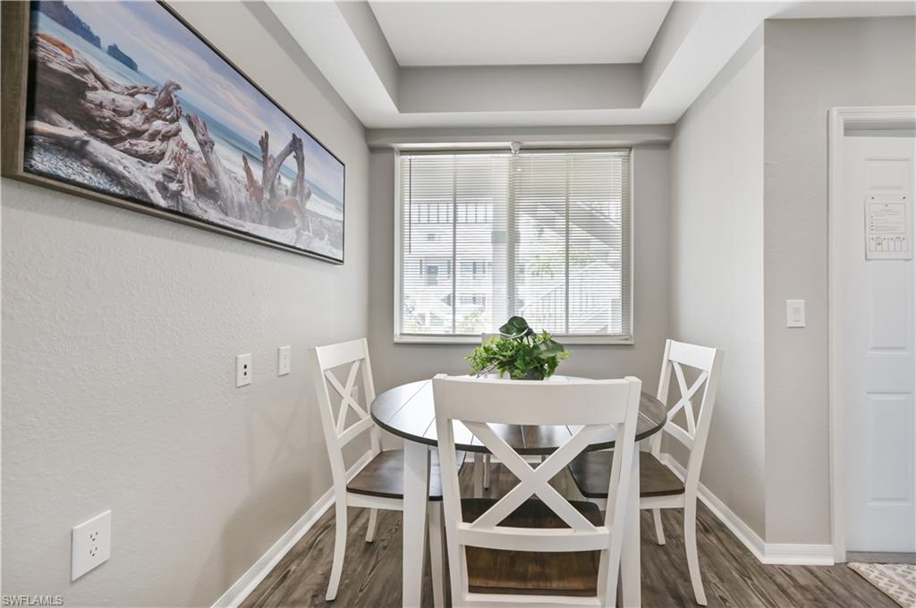 7915 Mahogany Run Lane, Unit 1115 Naples, FL 34113 - Photo 13 of 39 a view of a dining room with furniture and window