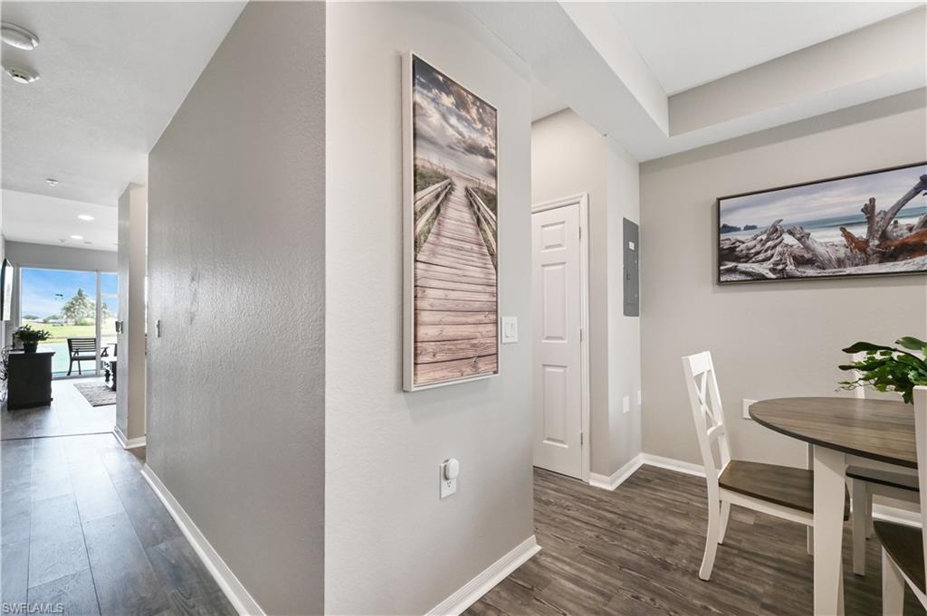 7915 Mahogany Run Lane, Unit 1115 Naples, FL 34113 - Photo 16 of 39 a view of a hallway with wooden floor and workspace