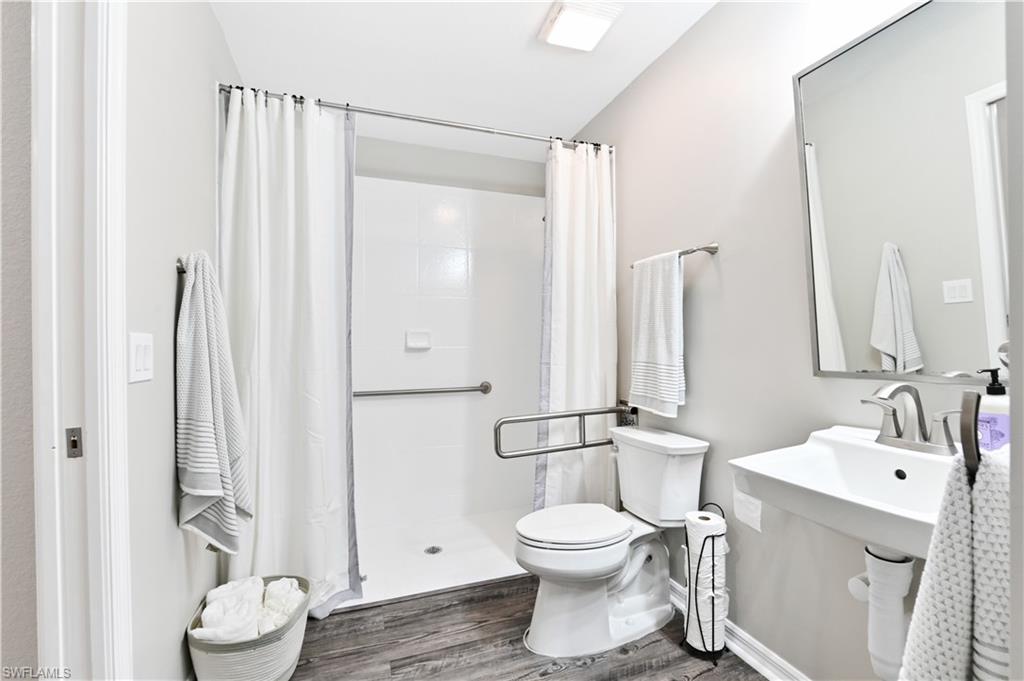 7915 Mahogany Run Lane, Unit 1115 Naples, FL 34113 - Photo 24 of 39 a bathroom with a toilet sink and shower