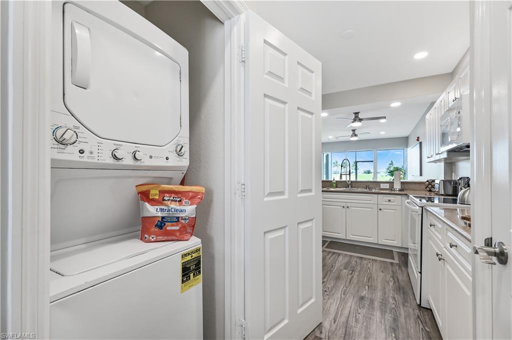 7915 Mahogany Run Lane, Unit 1115 Naples, FL 34113 - Photo 25 of 39 a kitchen with cabinets a sink and appliances