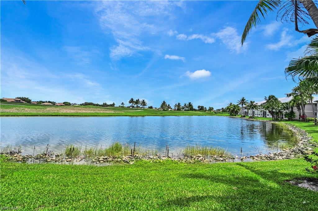 7915 Mahogany Run Lane, Unit 1115 Naples, FL 34113 - Photo 26 of 39 a view of a lake with houses in the background