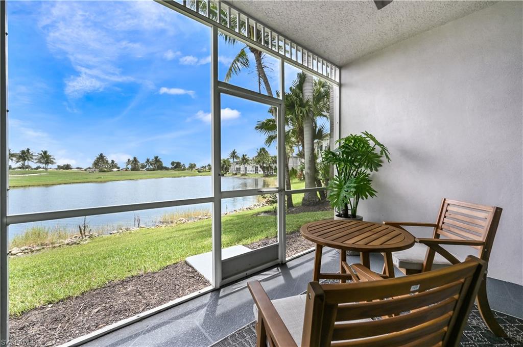 7915 Mahogany Run Lane, Unit 1115 Naples, FL 34113 - Photo 27 of 39 a view of a chairs and table in patio with a yard
