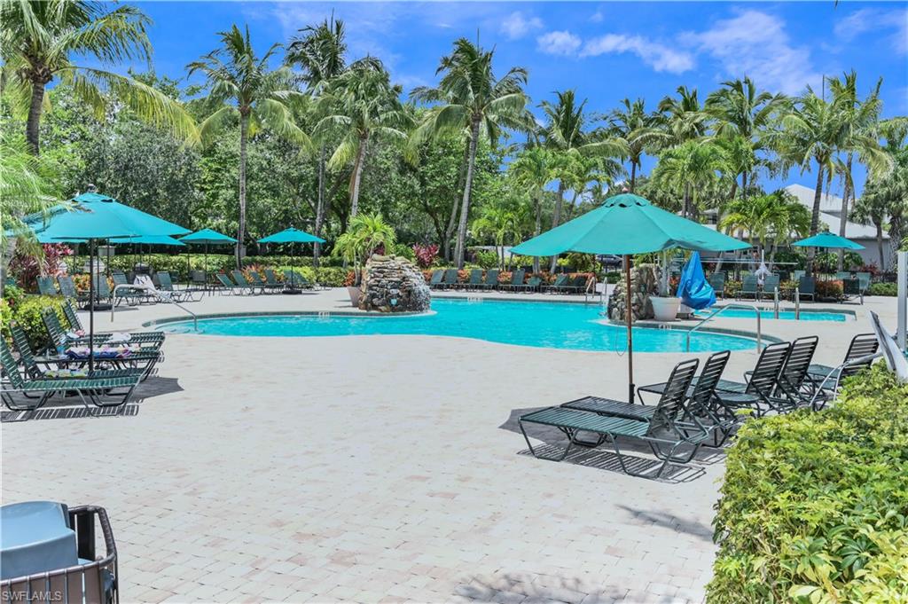 7915 Mahogany Run Lane, Unit 1115 Naples, FL 34113 - Photo 34 of 39 a swimming pool with outdoor seating water slide and yard