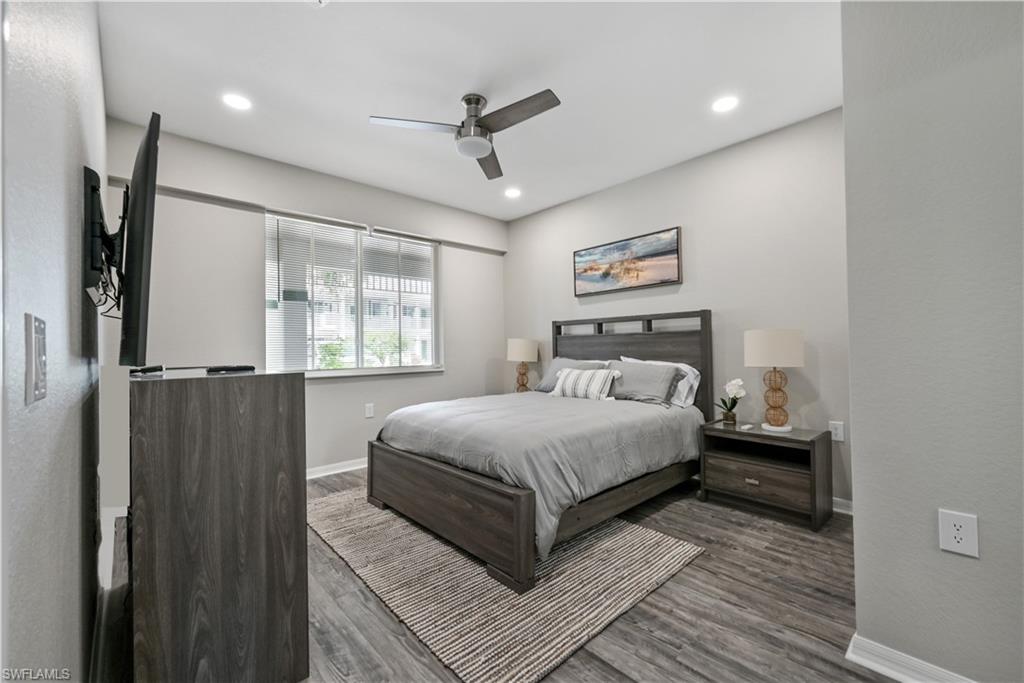 7915 Mahogany Run Lane, Unit 1115 Naples, FL 34113 - Photo 36 of 39 a bedroom with a large bed and a window