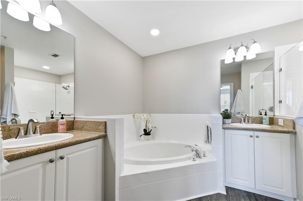 7915 Mahogany Run Lane, Unit 1115 Naples, FL 34113 - Photo 37 of 39 a bathroom with a double vanity sink and a mirror