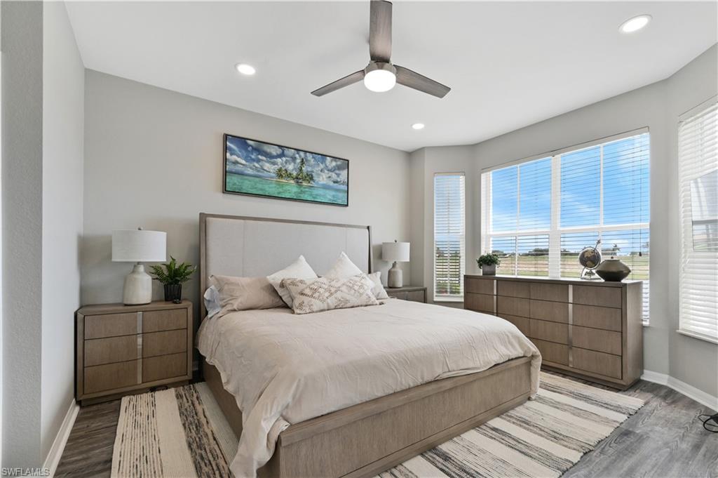 7915 Mahogany Run Lane, Unit 1115 Naples, FL 34113 - Photo 38 of 39 a bedroom with a large bed and a window