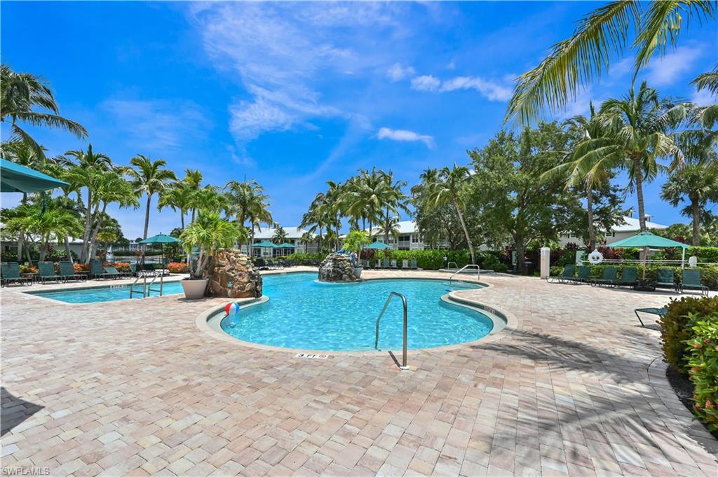 7915 Mahogany Run Lane, Unit 1115 Naples, FL 34113 - Photo 6 of 39 a view of a swimming pool with an outdoor space and seating area