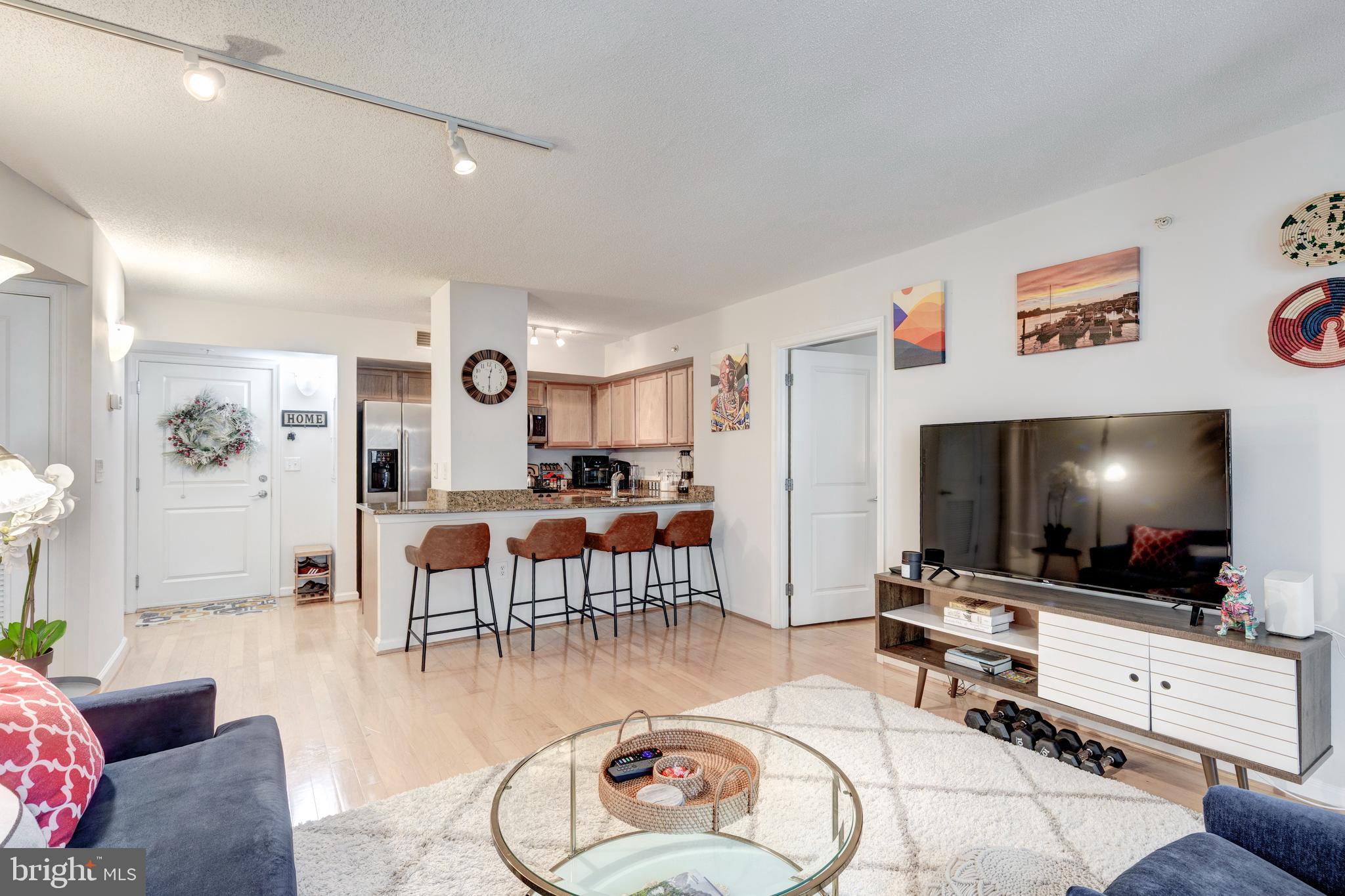 7923 Eastern Avenue Northwest, Unit 704 Silver Spring, MD 20910 - Photo 3 of 33 Family Room into Kitchen