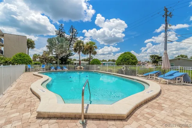 a view of a swimming pool with a lounge chairs