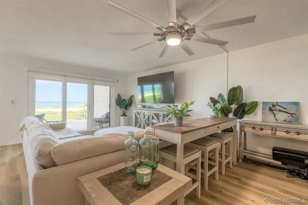 a living room with furniture a chandelier and a window