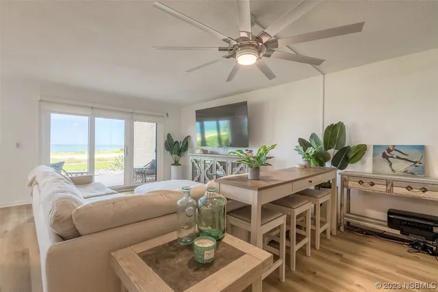 a living room with furniture a chandelier and a window
