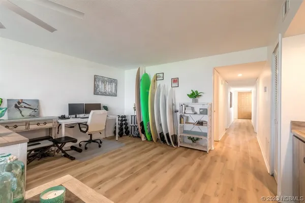 a view of a workspace with wooden floor and bedroom view