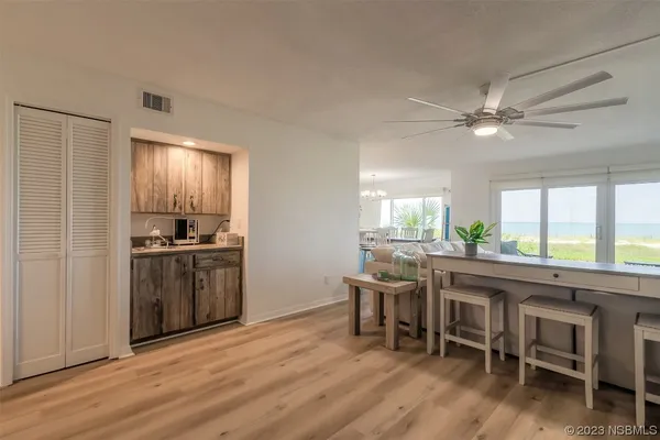 a kitchen with a table chairs refrigerator and cabinets