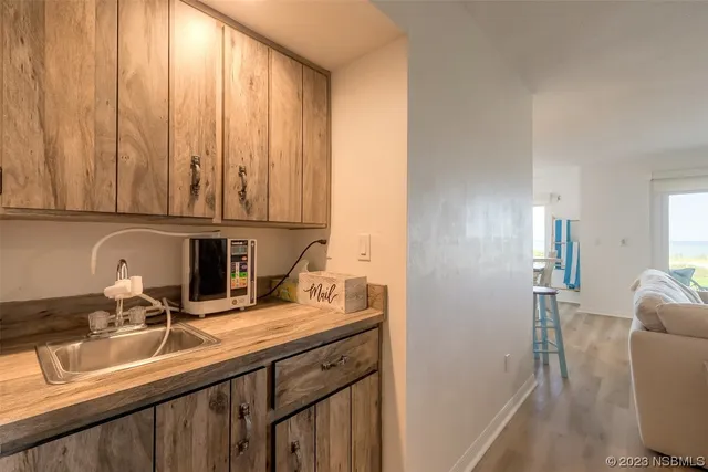 a kitchen with a sink cabinets and appliances