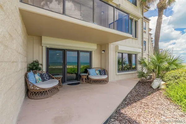 a view of a patio with couches and a potted plant