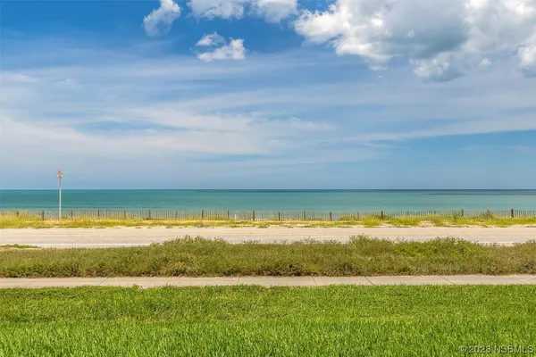 a view of a water with an ocean beach