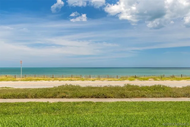 a view of a water with an ocean beach